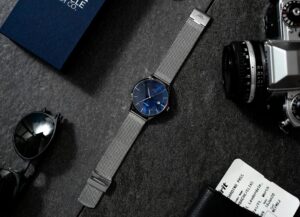 Sapphire Analog Watch Beside Analog Camera